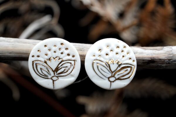 Each piece is handmade from porcelain clay and fired twice or three times in the kiln around 1200 degrees. Pottery is my passion and I love to discover new techniques, glazes, oxides or materials to play with and make extraordinary high quality jewellery. I also use hypoallergenic stainless steel and silver studs/hooks. White porcelain earrings with gold luster Pohutukawa flowers Christmas edition.