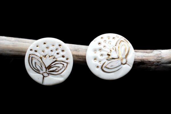 Each piece is handmade from porcelain clay and fired twice or three times in the kiln around 1200 degrees. Pottery is my passion and I love to discover new techniques, glazes, oxides or materials to play with and make extraordinary high quality jewellery. I also use hypoallergenic stainless steel and silver studs/hooks. White porcelain earrings with gold luster Pohutukawa flowers Christmas edition.