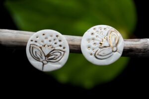 Porcelain gold Pohutukawa earrings Each piece is handmade from porcelain clay and fired twice or three times in the kiln around 1200 degrees. Pottery is my passion and I love to discover new techniques, glazes, oxides or materials to play with and make extraordinary high quality jewellery. I also use hypoallergenic stainless steel and silver studs/hooks.