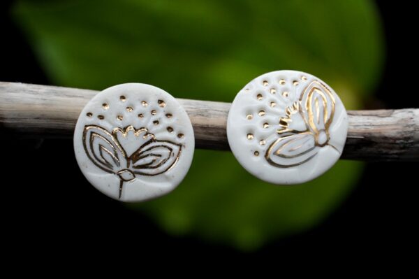 Porcelain gold Pohutukawa earrings Each piece is handmade from porcelain clay and fired twice or three times in the kiln around 1200 degrees. Pottery is my passion and I love to discover new techniques, glazes, oxides or materials to play with and make extraordinary high quality jewellery. I also use hypoallergenic stainless steel and silver studs/hooks.